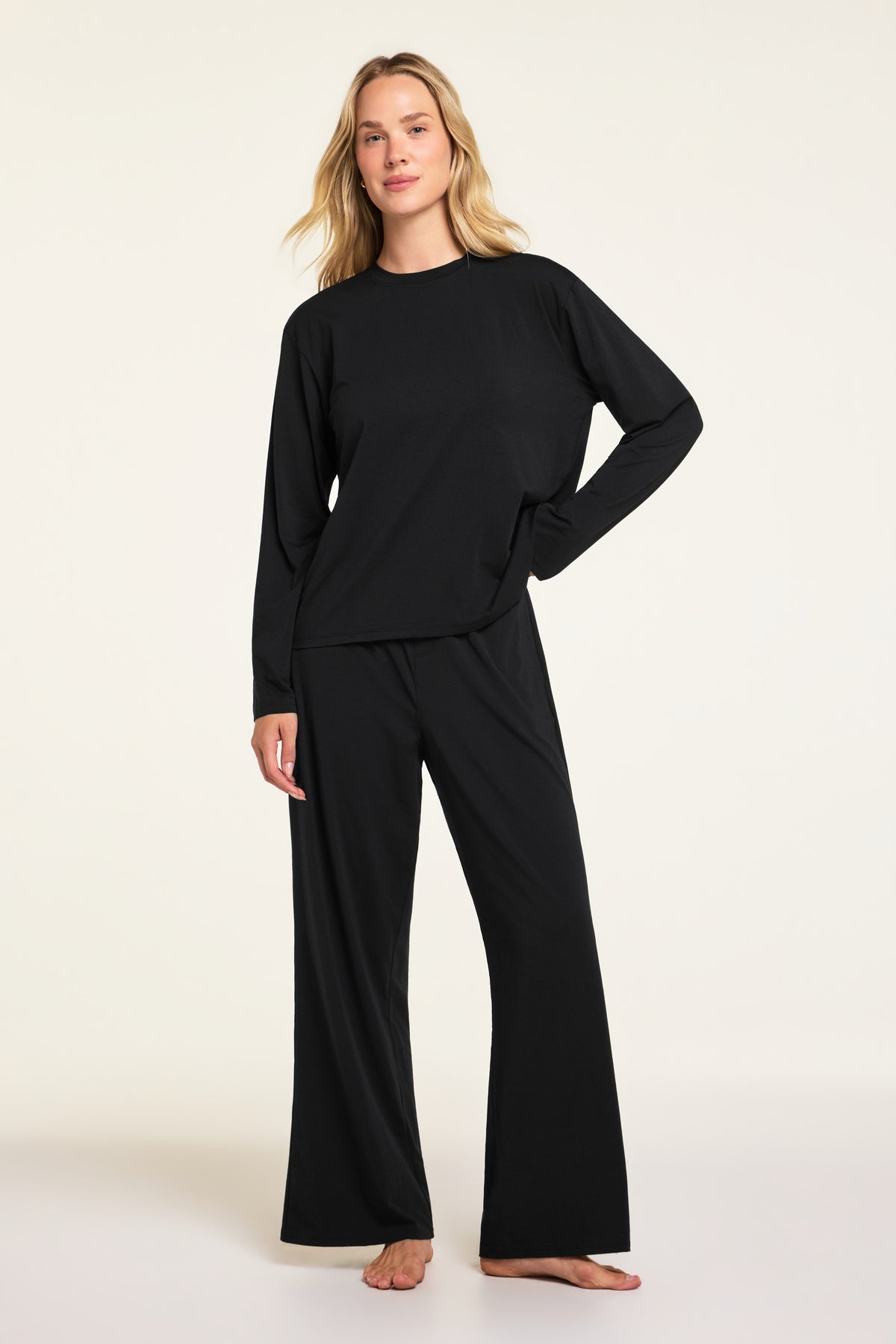 Side on-model view of the Cloud Cotton Long Sleeve T-Shirt in Black paired with the Cloud Cotton Pant in Black.