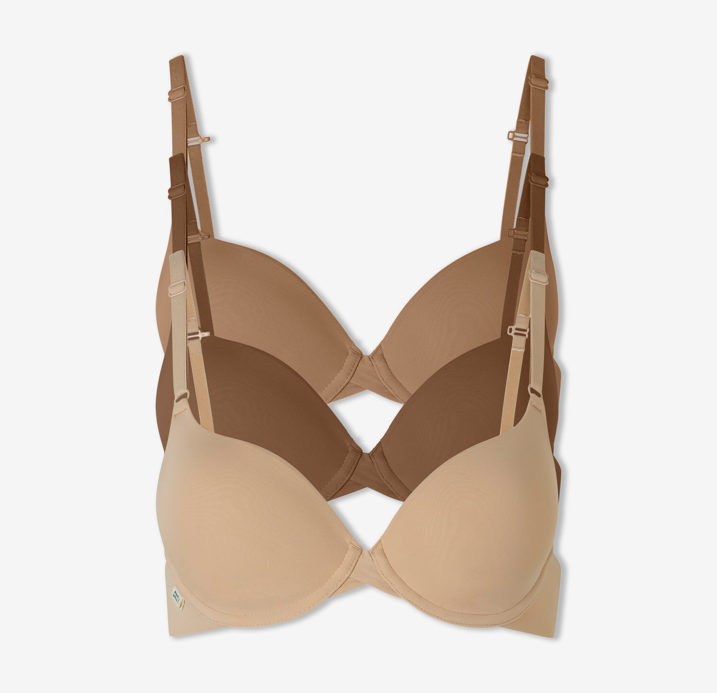 A trio of Harper Wilde's Base T-Shirt Bras in Tan, Brown, and Beige against a white background.