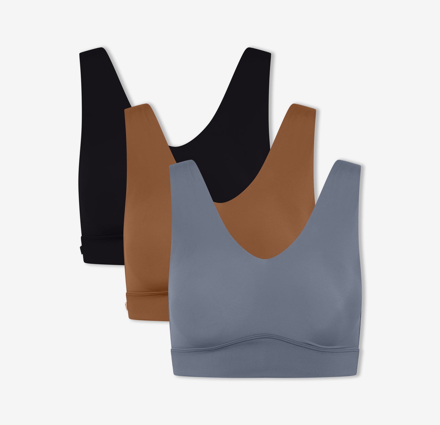 A trio of Harper Wilde's Bliss Bralettes in Black, Brown, and Steel which offer ultra-soft wireless support and comfort.