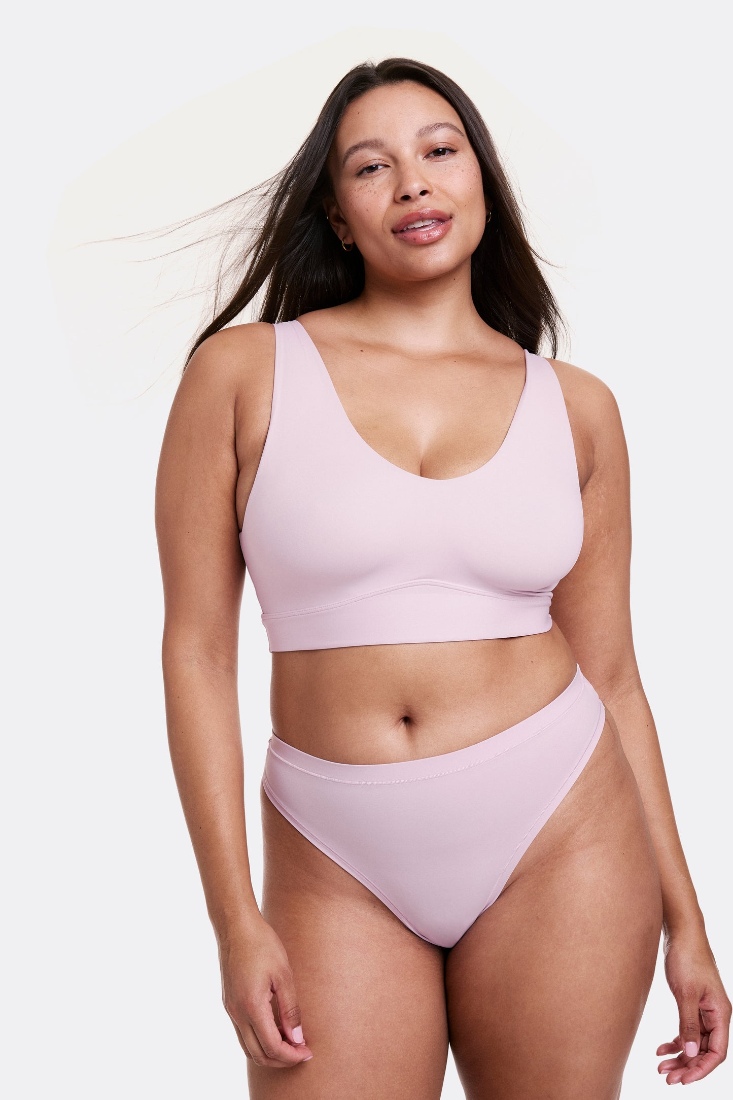 Full-body view of Alana wearing a Retro Lilac seamless bralette and matching underwear, designed with a smooth finish and flexible fit.