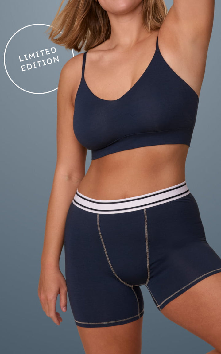 Two women wearing Cloud Cotton Triangle Bralette with Boxer Briefs and French Cut Brief in Midnight; both models pose against a blue background with “LIMITED EDITION” text badges.
