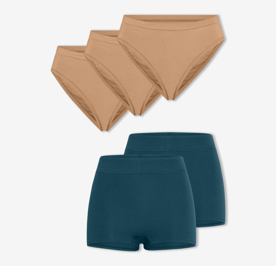 A trio of Harper Wilde's Cloud Cotton French Cut Briefs in Tan and a duo of Cloud Cotton Highwaist Boyshorts in Indigo against a white background.