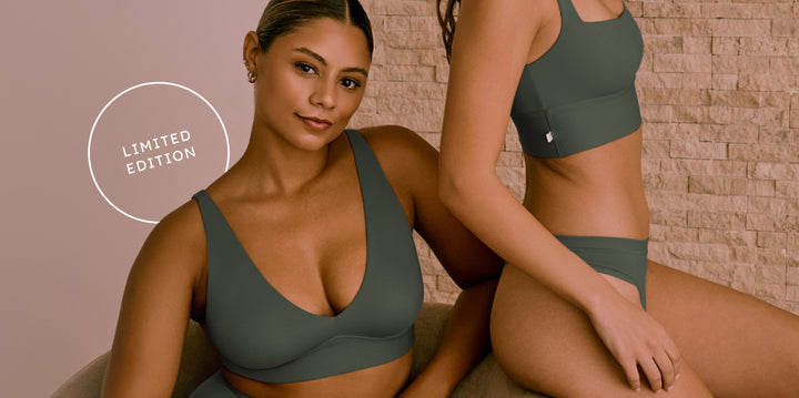 One model seated and smiling at the camera in the Bliss Plunge Adjustable Bralette and Bliss Highwaist Brief, while another model stands beside her wearing the Bliss Square Neck Bralette and Bliss underwear, all in the seasonal Fir color.  A circular badge says: “Limited Edition.”