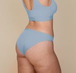 Three-quarter rear view of Summerlyn in the Bliss Bikini in Glacier. The image emphasizes the contoured fit and minimal seam construction of the underwear, paired with the coordinating Bliss Bralette.