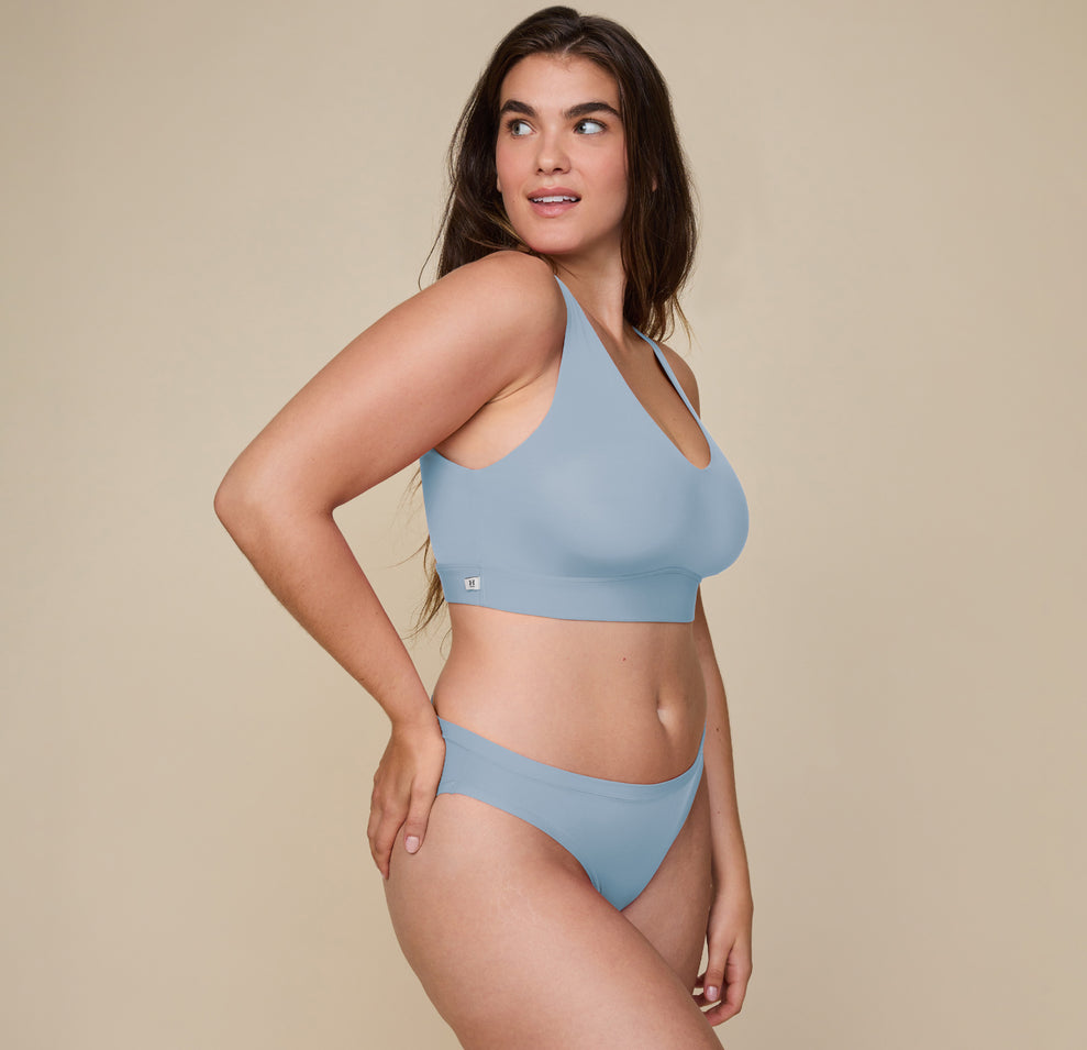 Full front view of Summerlyn wearing the Bliss Bikini and Bliss Bralette in Glacier. She stands with a relaxed smile, showcasing the smooth, stretchy fabric and comfortable mid-rise fit of the bikini.