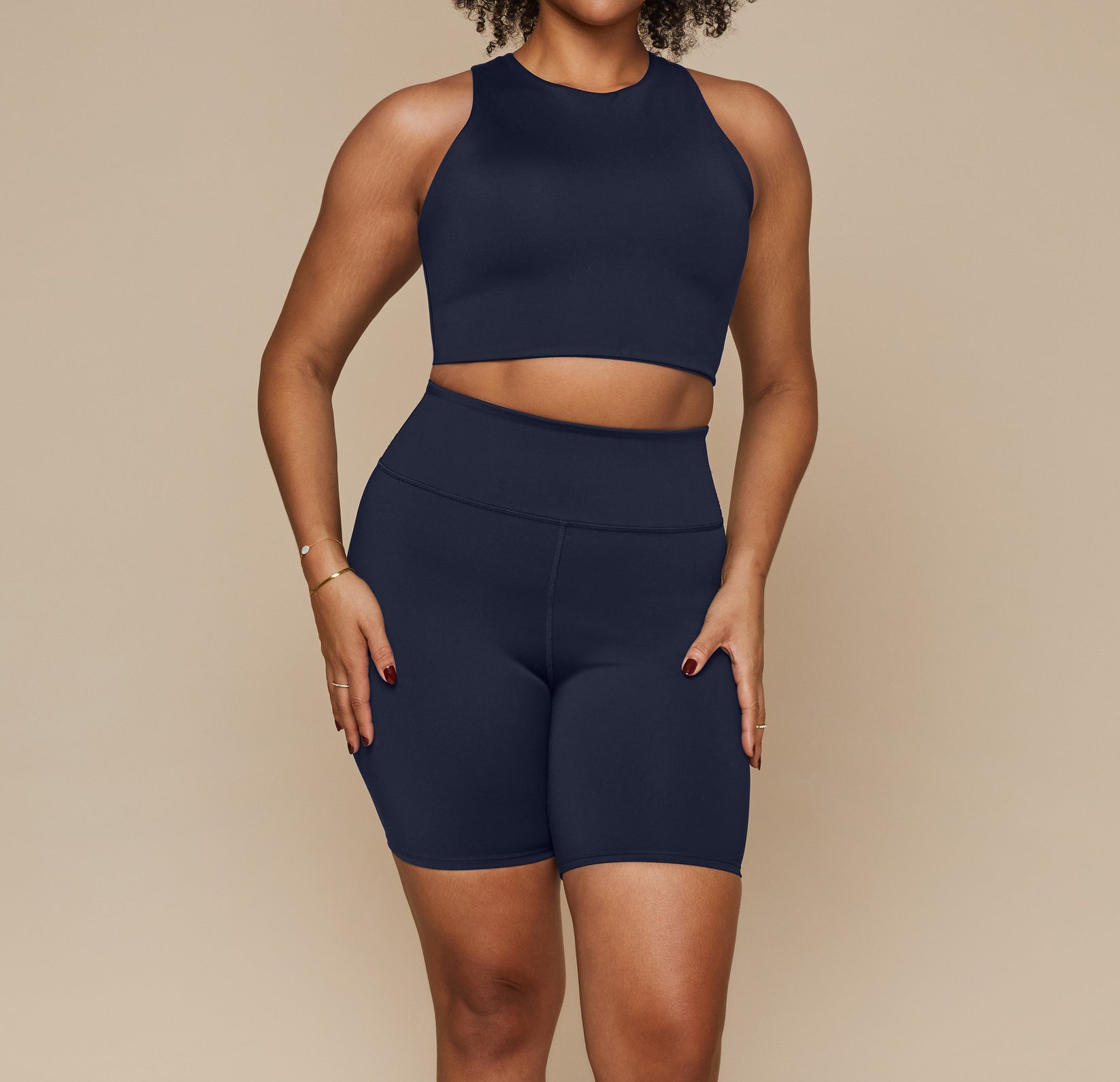 Model wearing the Flex Racerback Tank in the color Ink with the matching Flex High Rise Bikeshort. sizing:Alexandra wears size Large