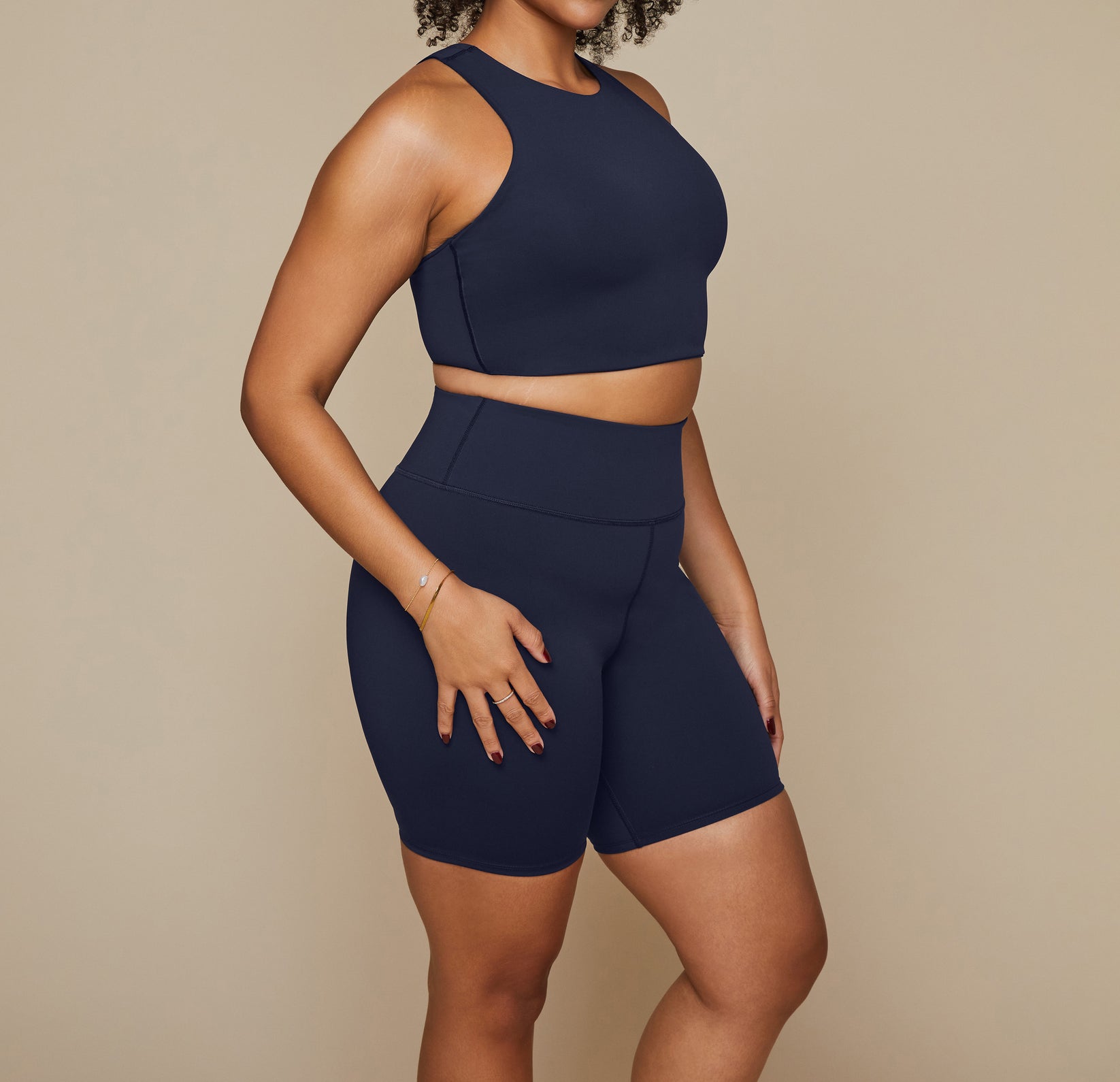 Model wearing the Flex Racerback Tank in the color Ink with the matching Flex High Rise Bikeshort.