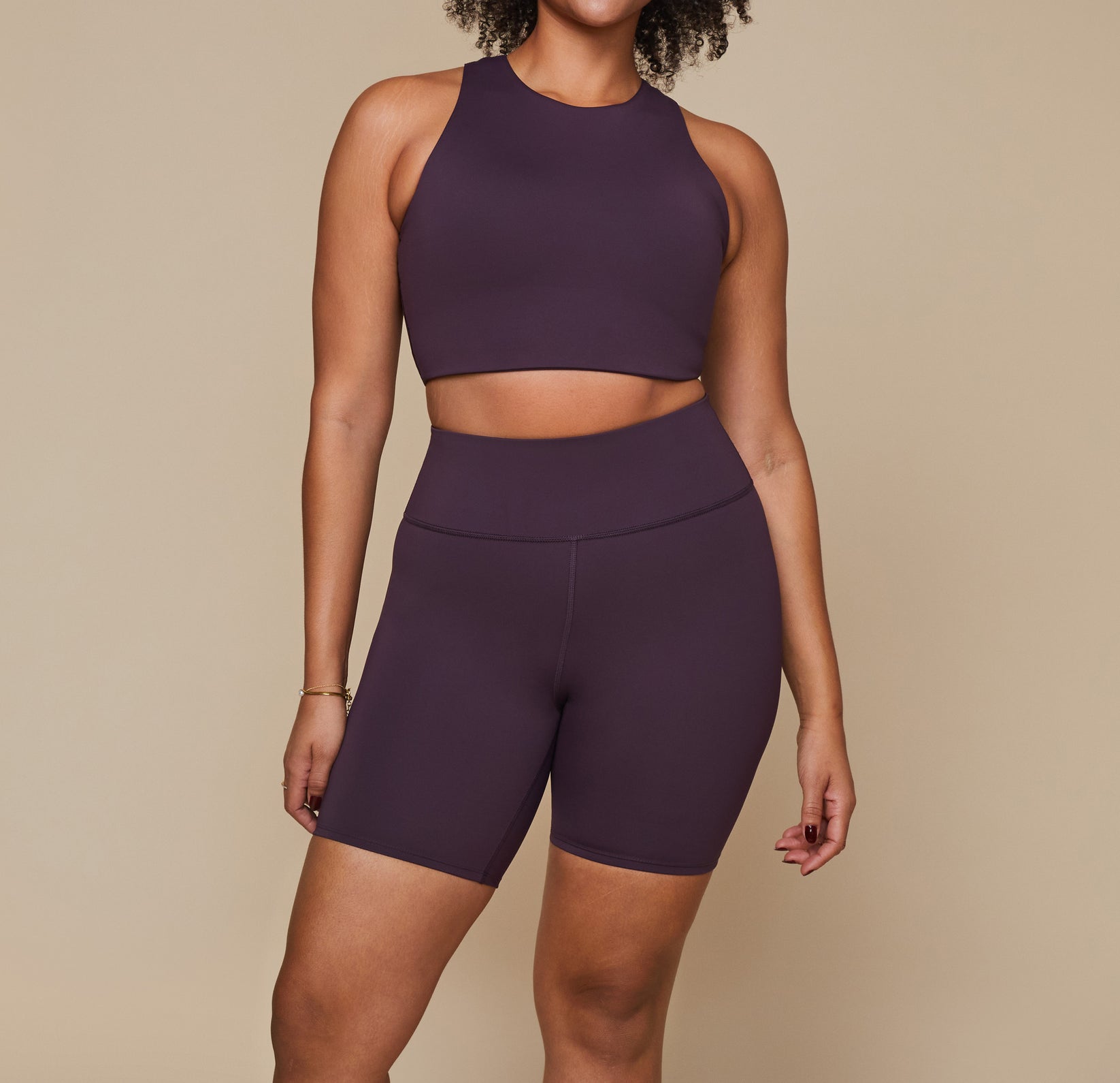 Model wearing the Flex Racerback Tank in the color Mulberry with the matching Flex High Rise Bikeshort. sizing:Alexandra wears size Large