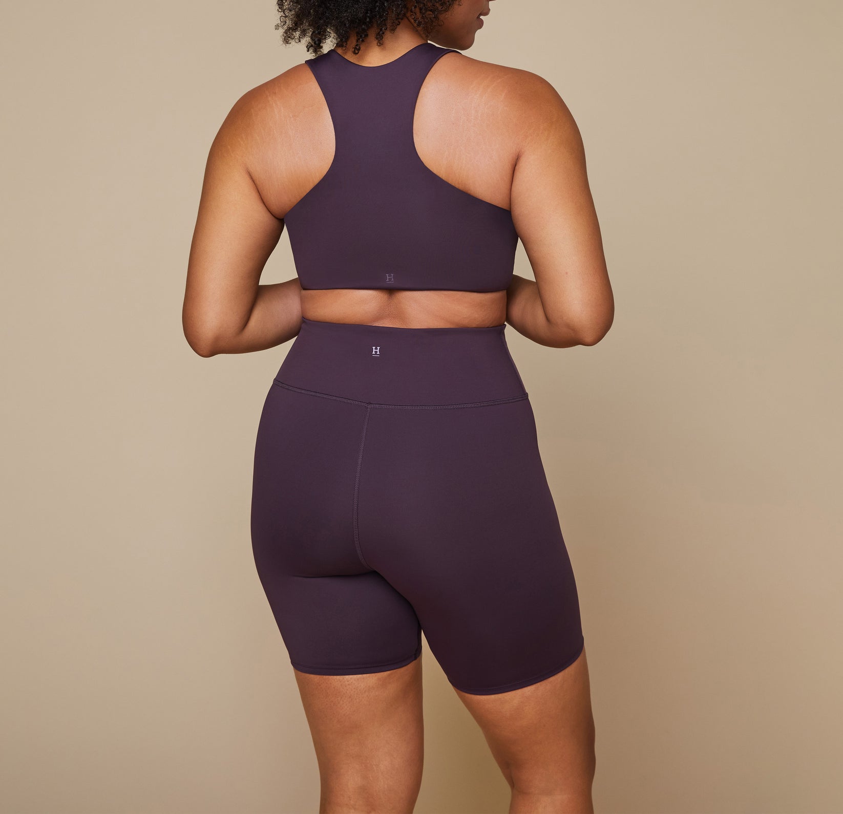 Close up of the back waist of the bike shorts showing the Harper Wilde "H" logo at the top center.