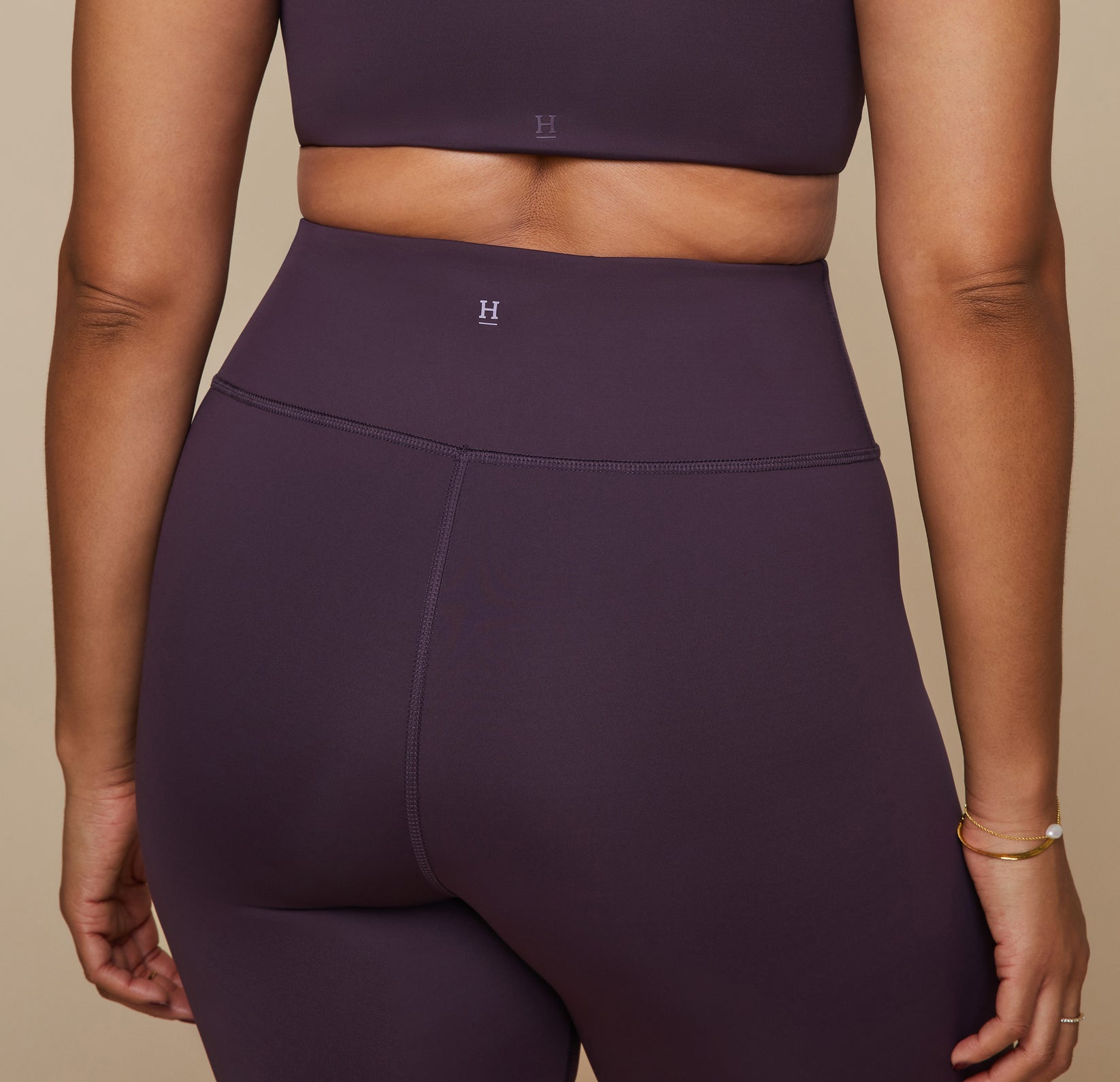 Close up of the back waist of the bike shorts showing the Harper Wilde "H" logo at the top center.