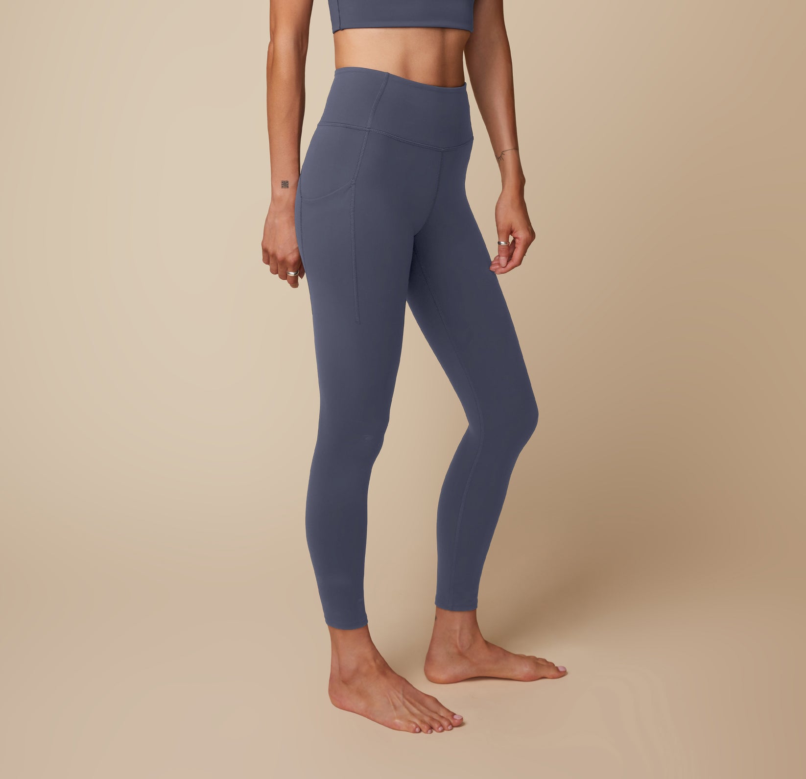 Anna in the Flex High Rise Legging and Flex Active Tank in Slate, emphasizing the side profile and sleek fit.