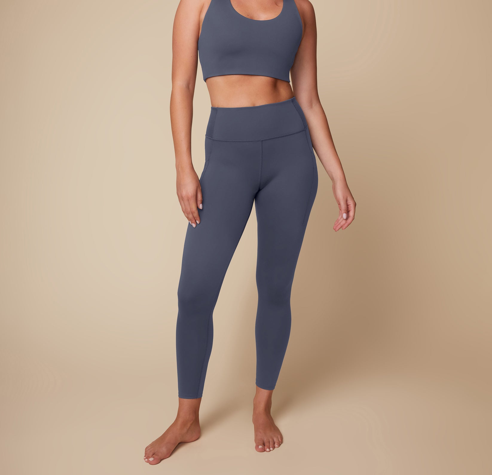 Front view of Megan wearing the Flex High Rise Legging and Flex Convertible Sports Bra in Slate. sizing: Megan wears size Medium