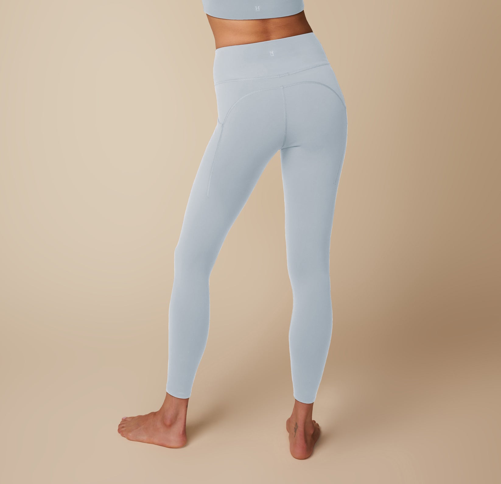 Back view of Anna wearing the Flex Convertible Sports Bra and Flex High Rise Legging in Thistle. sizing: Anna wears size Small