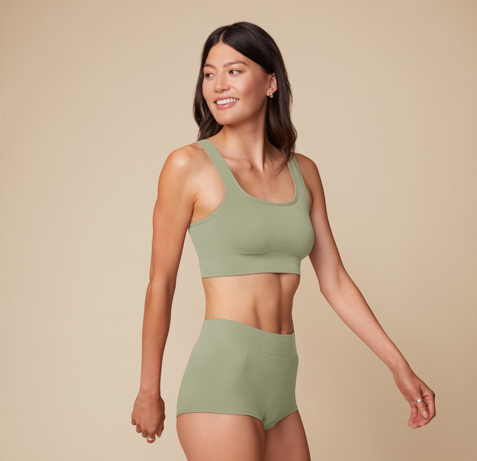 Side profile of model Anna wearing the Lounge Scoop Bralette and Lounge Boyshort in Sage.