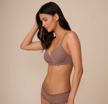 Marcela in a three quarter view wearing the Base Lace T-Shirt Bra and matching Bliss Lace Cheeky Brief in Mauve. The image highlights the flattering silhouette and soft microfiber fabric with scalloped lace details.