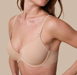 A close-up of Gracie in the Base T-Shirt Bra in Beige, focusing on the silky-smooth fabric, front-adjusting straps, and seamless construction.