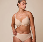 India wears the Base T-Shirt Bra in Beige, highlighting the lightly lined cups, supportive underwire, and ultra-soft fabric designed for all-day comfort. sizing: India wears size 36D