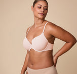 India poses in a three-quarter angle wearing the Base T-Shirt Bra in Rose, showcasing the bra’s contoured fit and comfortable support.