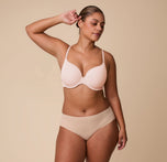 India models the Base T-Shirt Bra in Rose in a full-body shot to emphasize the bra’s lightly padded cups, front adjustable straps, and overall comfortable fit.