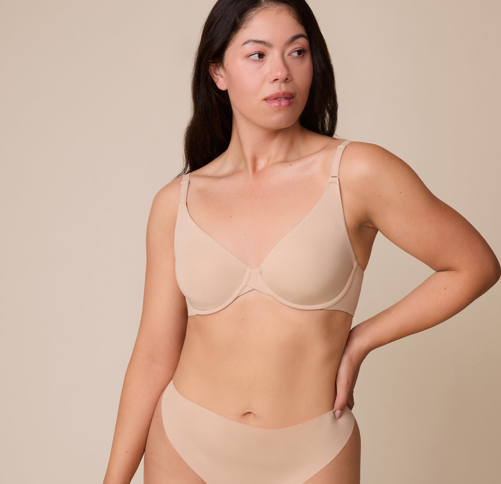 Emersyn wears the Base Unlined Bra in Beige, highlighting the smooth, unlined cups and lightly supportive underwire for a barely-there feel. sizing: Emersyn wears size 36C