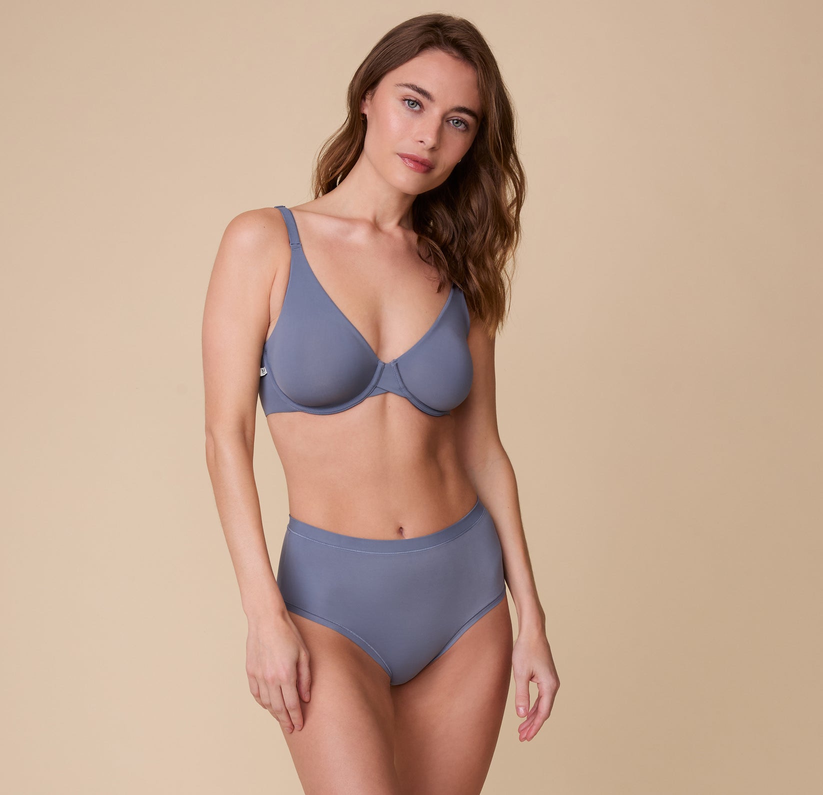 A full-body shot of Gracie in the Base Unlined Bra in Steel, paired with the matching Bliss Highwaist Brief highlighting the smooth, lightweight fabric perfect for all-day wear.