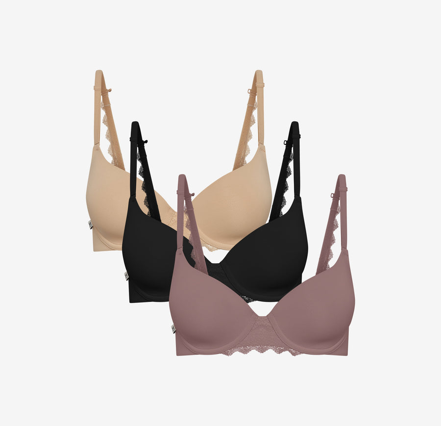 Harper Wilde Base Lace T-Shirt Bra in beige, black, and mauve, shown in a staggered front-facing display to highlight lace strap and band detailing on each color.