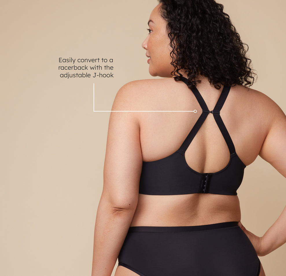 Bianca wears the Base Wirefree Bra with the straps converted into a racerback using the J-hook, demonstrating the bra’s versatility for different outfits. A tagline reads, "Easily convert to a racerback with the adjustable J-hook."