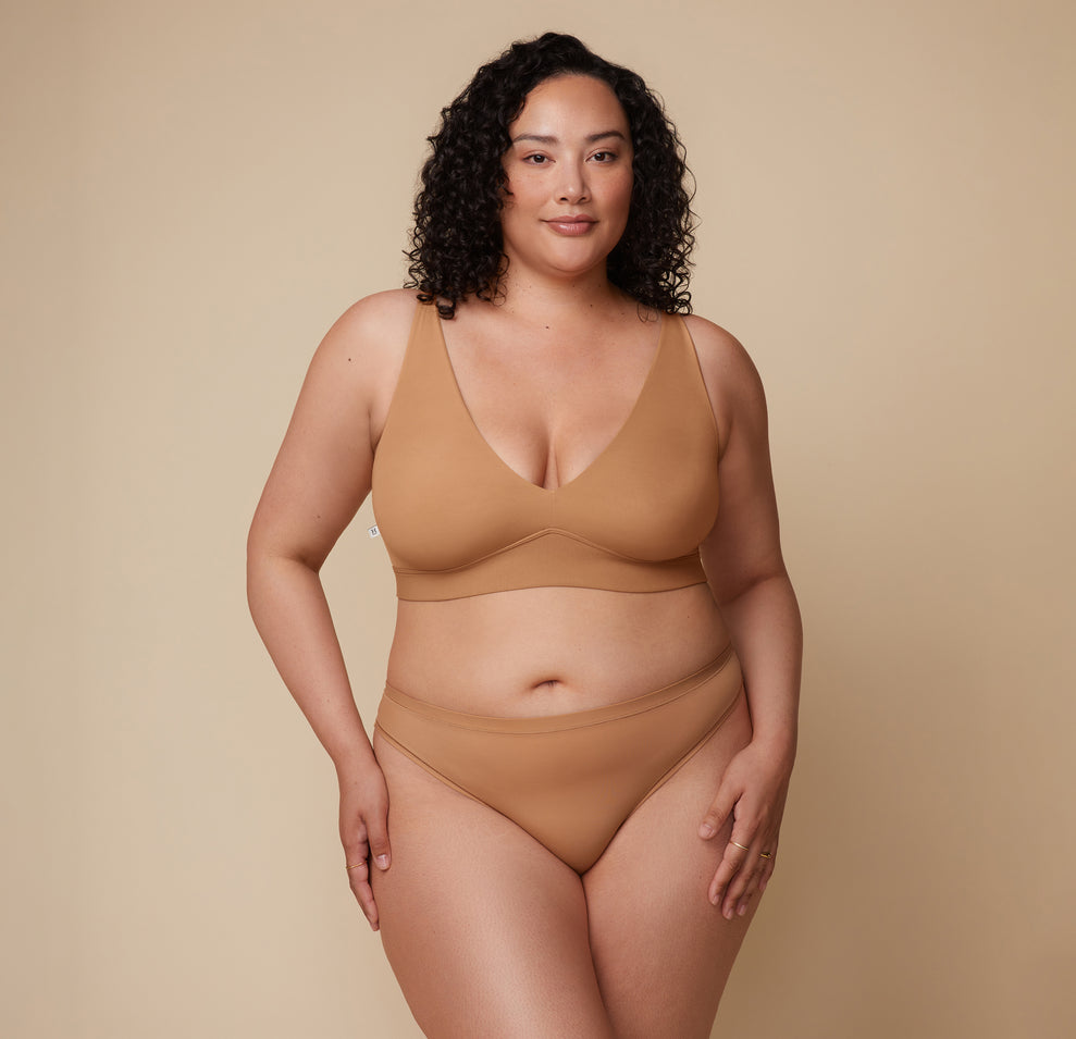 Bianca in the Bliss Plunge Adjustable Bralette and Bliss Thong, standing forward with a relaxed stance. sizing: Bianca wears size XL