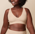 Akesha in the Bliss Plunge Adjustable Bralette and Bliss Highwaist Brief in Beige, highlighting the adjustable straps and smooth fabric of the bralette, perfect for all-day wear. sizing: Akesha wears size Large