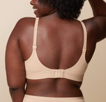 Back view of Akesha in the Bliss Plunge Adjustable Bralette in Beige, highlighting the standard strap configuration.