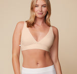 Megan wearing the Bliss Plunge Adjustable Bralette in Beige with the Lounge Rib Boyshort in White, front view. sizing: Megan wears size Medium. Sizes L-4XL have higher center in front for additional support.