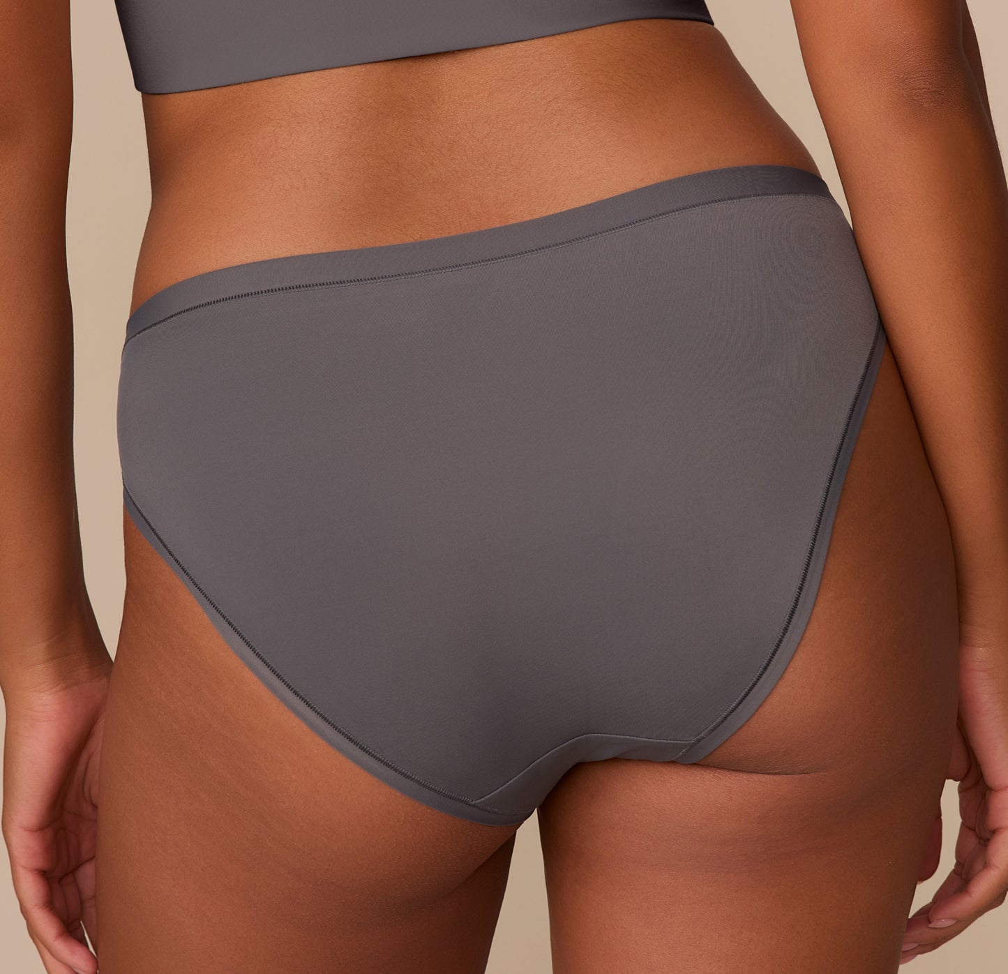 Close-up of the back of the Bliss Bikini in Smoke, focusing on the smooth finish and full-coverage fit around the hips and waist.