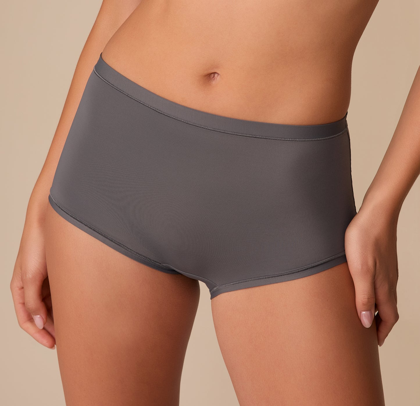 Extreme close-up of the Bliss Boyshort in Smoke on Alexis, focusing on the soft waistband and smooth finish around the hips.