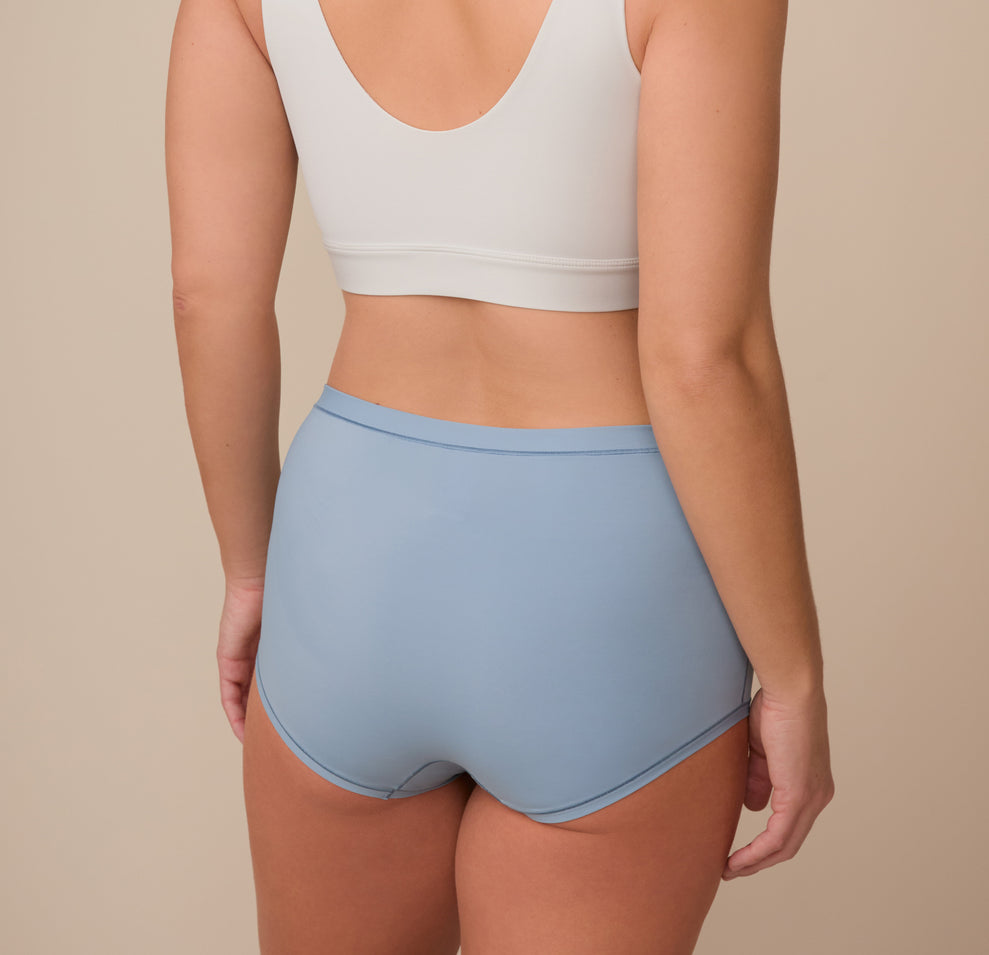 Back view of Sonnie in the Bliss Boyshort in Glacier. The image shows the boyshort’s full back coverage and smooth construction.