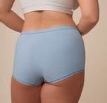 Rear close-up of Sonnie in the Bliss Boyshort in Glacier. The photo emphasizes the boyshort’s gentle stretch and soft finish across the hips and back.