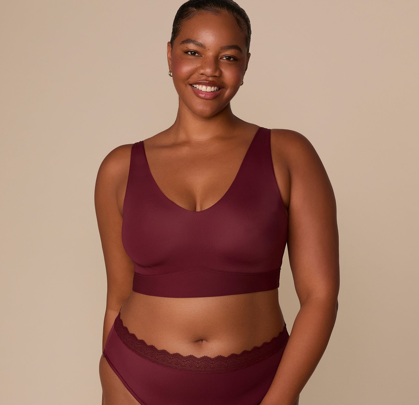 Front view of Zarria wearing the Bliss Bralette in Bordeaux and matching Bliss Lace Highwaist Brief, emphasizing the coordinated set. sizing: Zarria wears size XL