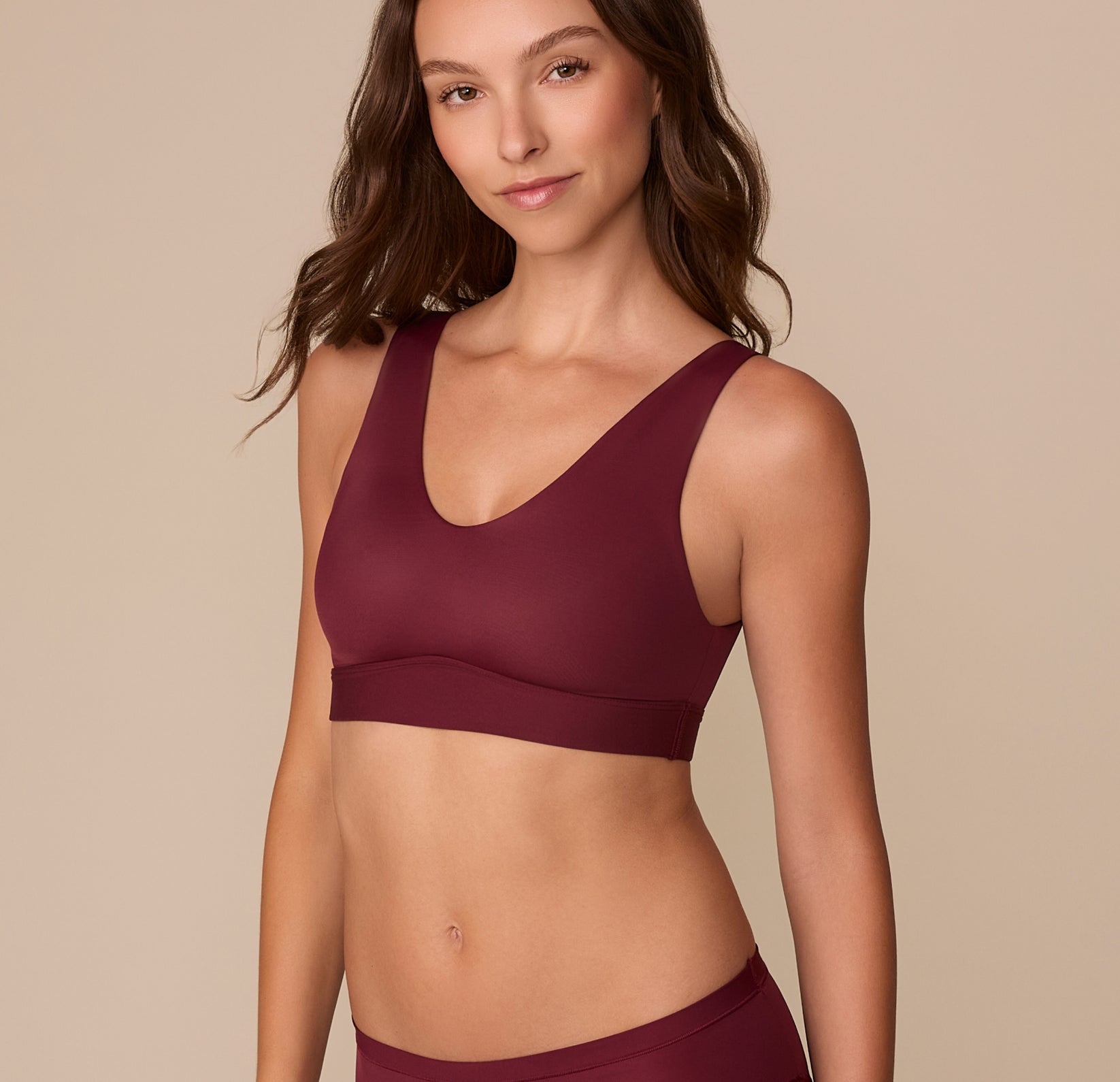 Side view of Alexis in the Bliss Bralette in Bordeaux, showcasing the comfortable fit and subtle V-neckline.