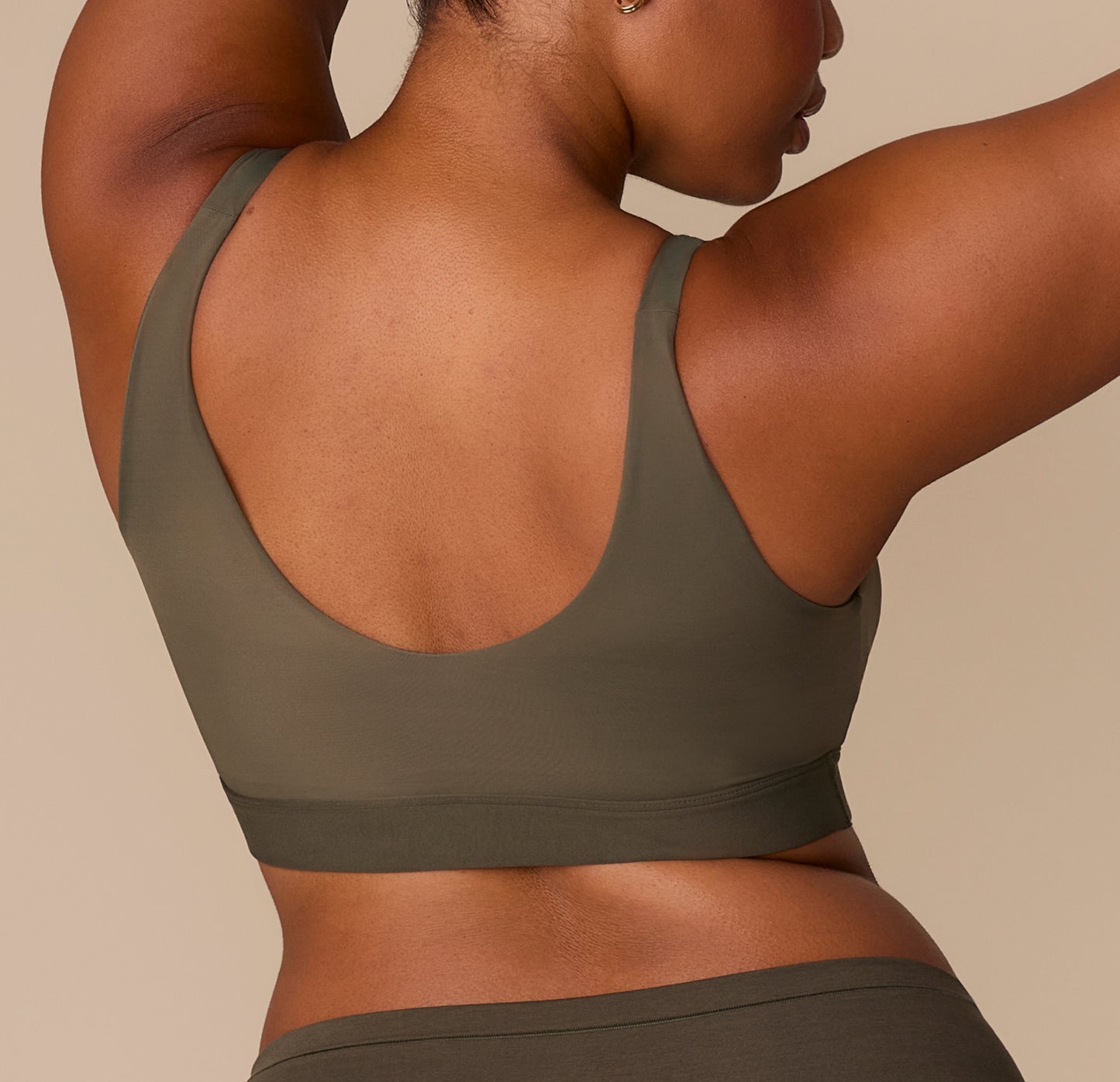 Back view of Zarria in the Bliss Bralette in Olive, showing the smooth scoop-back and minimal seam underband for a clean finish.