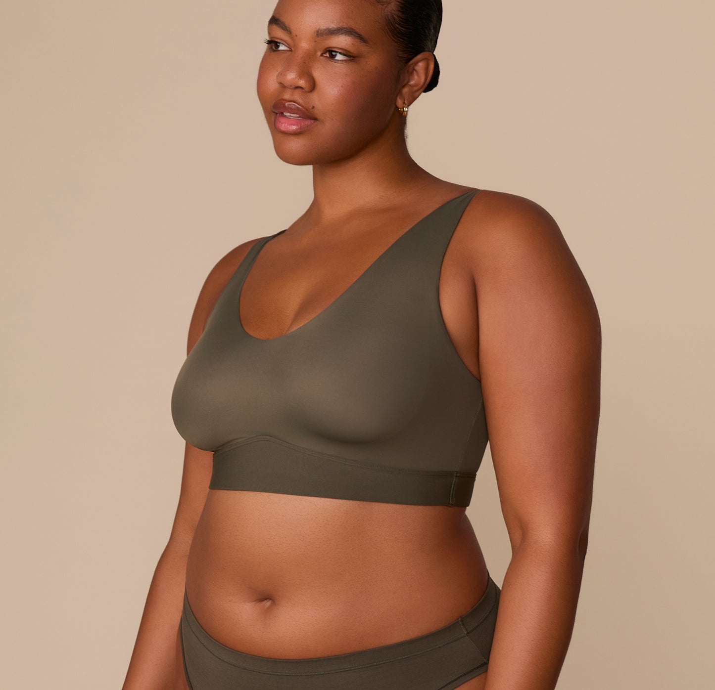 Side angle of Zarria in the Bliss Bralette in Olive, paired with the Bliss Bikini, showing the flexible fabric and everyday comfort fit.
