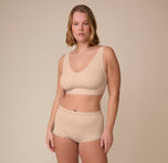 Full body view of Victoria in the Bliss Bralette and Bliss Highwaist Boyshort in Beige. The set is soft, supportive, and designed to feel like a second skin.