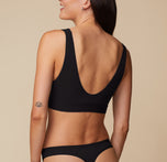 Back view of Anna wearing the Bliss Bralette in Black. The scoop back lays flat against the skin, offering wire-free comfort that moves with you.