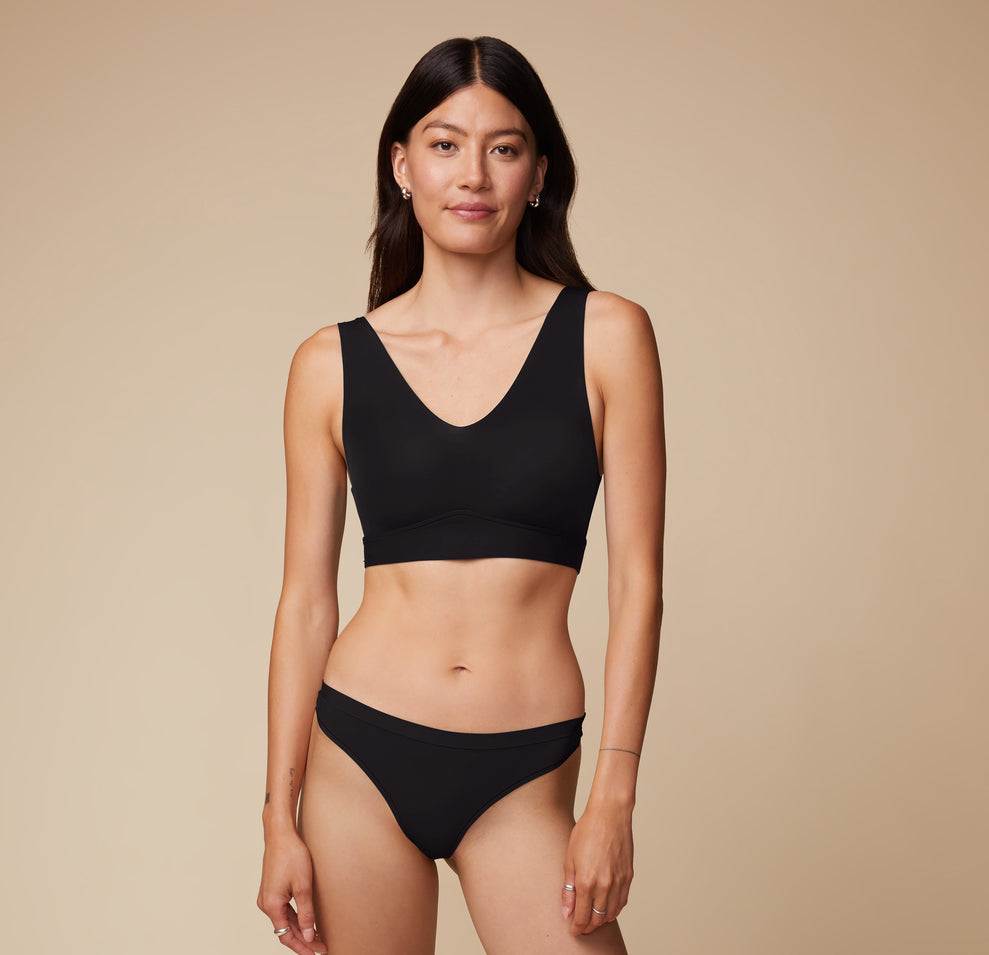 Full body view of Anna in the Bliss Bralette and matching Bliss Thong in Black. The classic color and sleek design deliver an elevated everyday look.