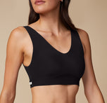 Close-up of Anna in the Bliss Bralette in Black. The image highlights the subtle shaping, wide straps, and smooth underband.