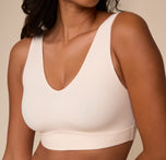 Close-up of the Bliss Bralette on Victoria in Quartz. A detailed view of the V-neckline on the Bliss Bralette in Quartz. The buttery-soft fabric lies flat under clothing and molds gently to the body.