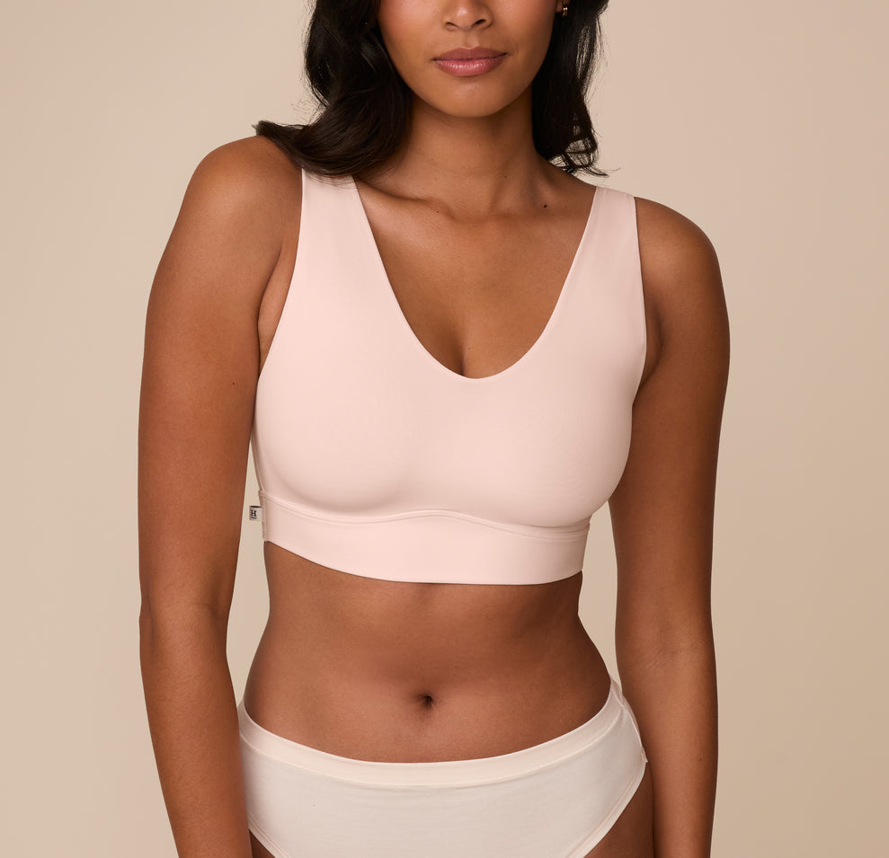 Front view of Victoria wearing the Bliss Bralette in Rose. The soft V neckline and wide straps offer a smooth fit with minimal seams and a supportive underband. sizing: Victoria wears size Medium