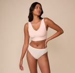 Full body view of Victoria wearing the Bliss Bralette in Rose. The clean lines and soft blush tone create an effortless everyday look.