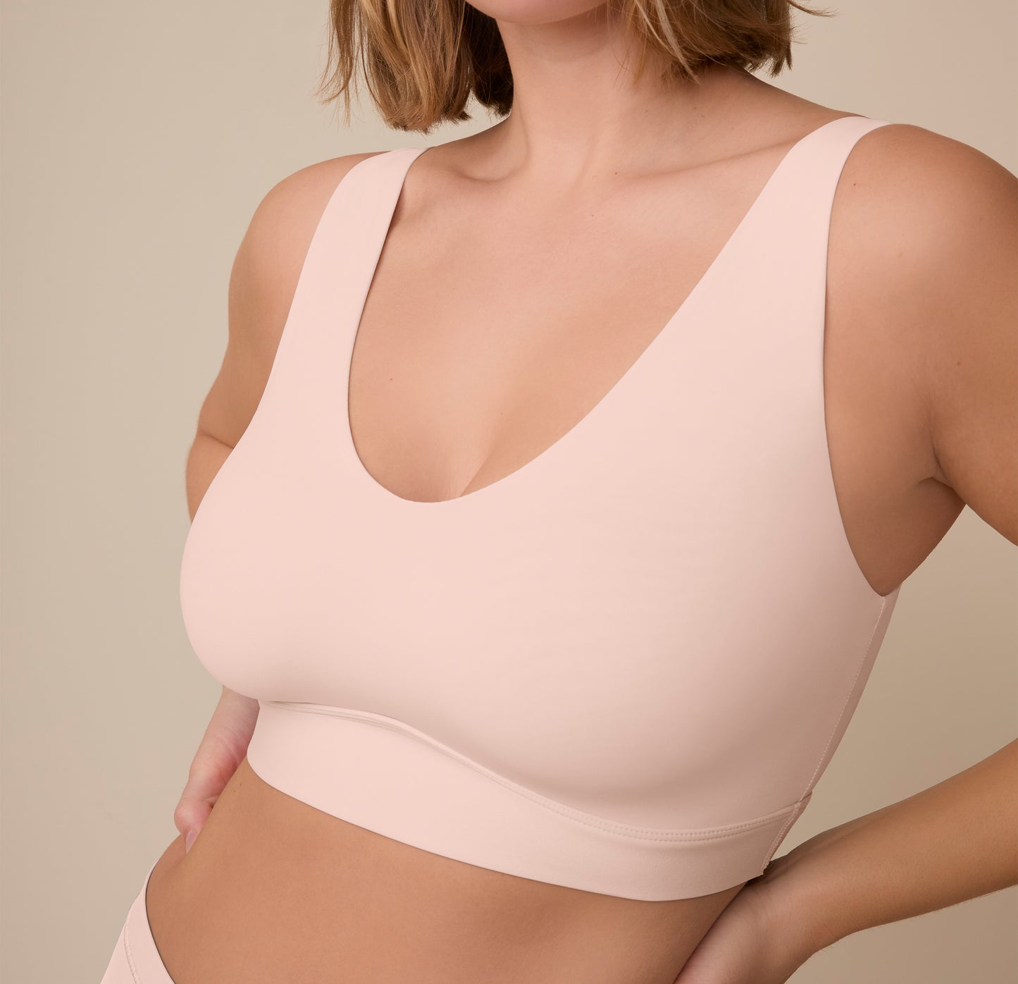 Close-up side angle of Sonnie wearing the Bliss Bralette in Rose. The image captures the smooth fabric and flexible support designed for real, everyday comfort.