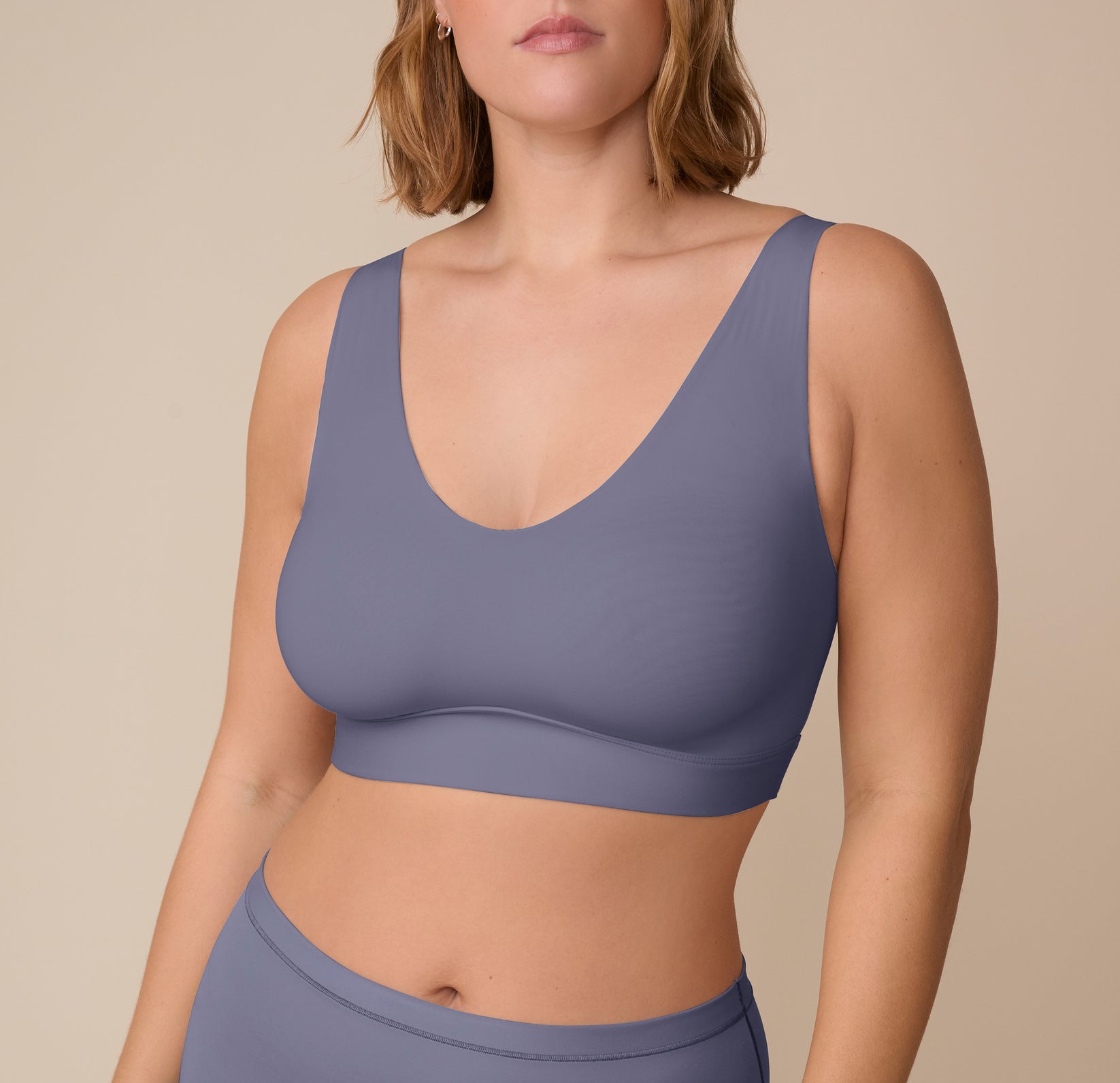 Front view of Sonnie wearing the Bliss Bralette in Steel. The deep V neckline and wide straps highlight the ultra-soft fabric and smooth design with minimal seams. sizing: Sonnie wears size XL