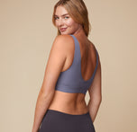 Back view of Megan wearing the Bliss Bralette in Steel. The scoop back reveals the bralette’s sleek silhouette and non-restrictive design.