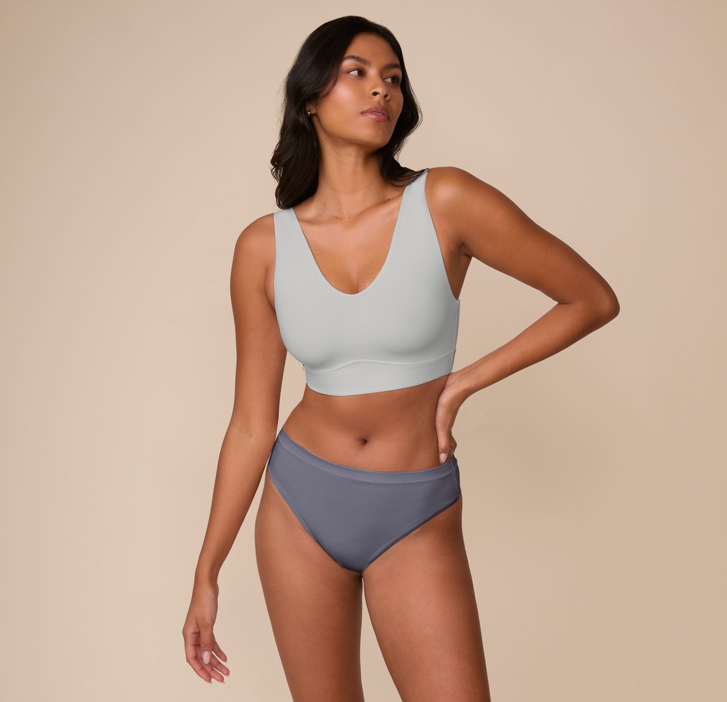Full-body shot of Victoria wearing the Bliss Bralette in Stormy. The image emphasizes comfort and minimal seams in an everyday set.